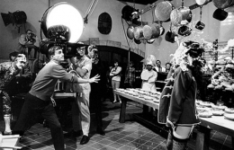 Blake Edwards throwing a pie at Natalie Wood on the set of The Great Race, Warner Bros. Studio, Burbank, California, 1964