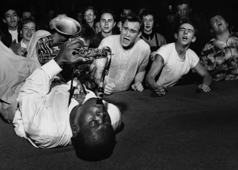 Big Jay McNeely, lying on the stage of the Los Angeles Olympic Auditorium, 1951