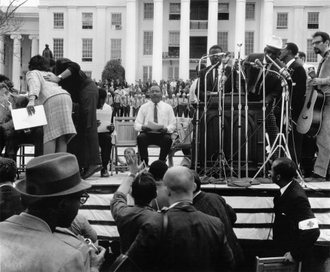 Martin Luther King Jr. waiting to be introduced at the Alabama Capitol after leading the fifty-four mile march from Selma to Montgomery, 1965, Archival Pigment Print