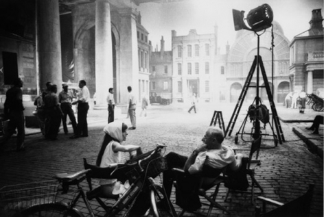 Audrey Hepburn & George Cukor chat after filming has finished for the day, on the Covent Garden set of My Fair Lady, 1963