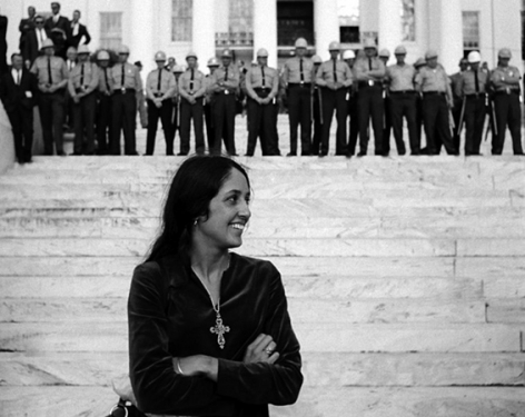 Joan Baez, folk singer, in front of State Troopers, Montgomery Alabama State House. Conclusion of Selma To Montgomery Alabama Civil Rights March, March 25, 1965