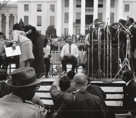 Martin Luther King Jr. waiting to be introduced at the Alabama Capitol after leading the fifty-four mile march from Selma to Montgomery, 1965, Archival Pigment Print